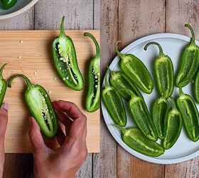 air fryer jalapeno poppers quick easy appetizer, Slicing large jalape os in half lengthwise on a cutting board and scooping out seeds and membranes with a spoon to prep for air fryer jalape o poppers