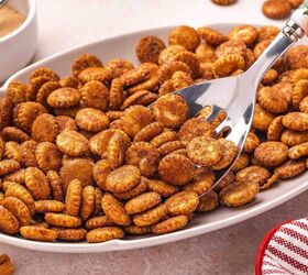 the best cinnamon sugar oyster crackers recipe, A silver ladle scooping cinnamon sugar oyster crackers from a serving platter the shiny metallic spoon contrasting beautifully against the warm golden caramelized coating of each crispy cracker