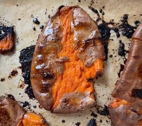 smashed and loaded sweet potatoes with creamy green sauce, Smashed sweet potatoes on a baking sheet brushed with honey butter after roasting until crisp and caramelized