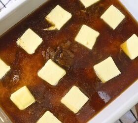 viral stick of butter rice easy baked butter rice recipe, A baking dish with rice soup broth and seasonings topped with pats of butter