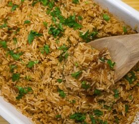 viral stick of butter rice easy baked butter rice recipe, Stick of butter rice in a baking dish being served with a wooden spoon
