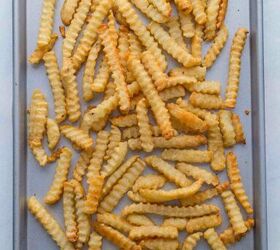 nacho fries with ground beef easy 30 minute recipe, A baking sheet covered with a scattered layer of crispy golden crinkle cut French fries
