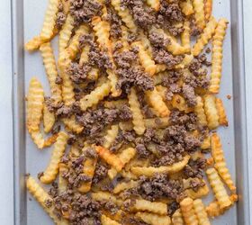 nacho fries with ground beef easy 30 minute recipe, A baking sheet topped with crinkle cut French fries and browned ground beef scattered over them