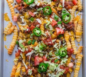 nacho fries with ground beef easy 30 minute recipe, Crinkle cut fries on a baking sheet topped with melted cheese ground beef diced tomatoes shredded lettuce salsa and sliced jalape os