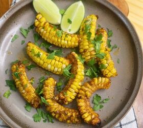 cajun butter corn ribs easy cajun corn ribs recipe, Overhead image of Cajun Butter Corn Ribs with parsley and lime wedges