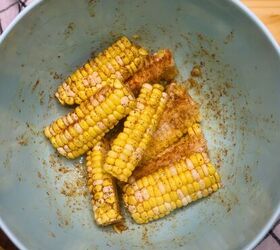 cajun butter corn ribs easy cajun corn ribs recipe, seasoned corn ribs in a blue bowl