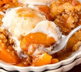 peach cobbler with fresh milled flour, Creamy peach cobbler with vanilla ice cream and whipped cream in a white bowl