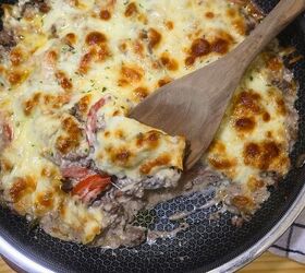 ground beef cheesesteak casserole recipe low carb meal, Ground Beef Cheesesteak Casserole in a skillet with a wooden spoon