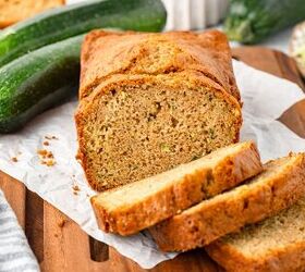 einkorn zucchini bread, Zucchini bread loaf with slices on a wooden board fresh and grated zucchini in the background