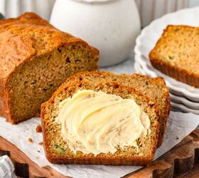 einkorn zucchini bread, Sliced Einkorn zucchini bread on parchment lined board with buttered slice in front and jars in background