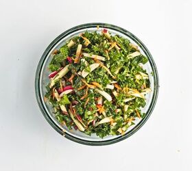 easy kale apple salad with lemon miso dressing, Lemon miso dressing poured over kale apples carrots and radishes in a mixing bowl