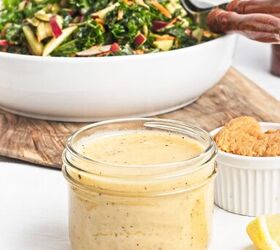 easy kale apple salad with lemon miso dressing, Close up of lemon miso dressing in a glass jar served alongside fresh kale apple salad