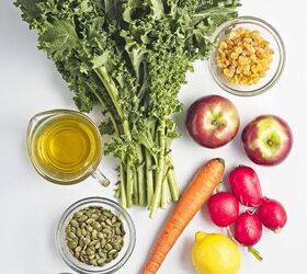 easy kale apple salad with lemon miso dressing, ngredients for kale apple salad including fresh kale apples carrot radishes pumpkin seeds raisins lemon olive oil miso paste maple syrup salt and black pepper