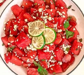 easy kale apple salad with lemon miso dressing, Top down view of watermelon strawberry salad with feta cheese mint and lime in a white bowl beside lime slices