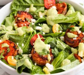 easy kale apple salad with lemon miso dressing, Blackened shrimp salad with avocado dressing cherry tomatoes feta cheese and romaine lettuce in a white bowl
