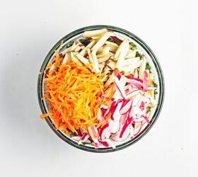 easy kale apple salad with lemon miso dressing, Julienned apples shredded carrot and sliced radishes prepared on a cutting board