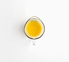 easy kale apple salad with lemon miso dressing, Lemon miso dressing ingredients combined in a glass measuring cup before mixing
