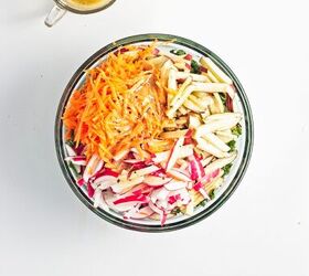 easy kale apple salad with lemon miso dressing, Chopped kale topped with apples carrots and radishes in a mixing bowl