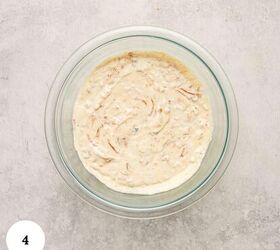 greek yogurt french onion dip with real caramelized onions, A glass bowl filled with creamy greek yogurt french onion dip containing visible onion pieces sits on a light gray textured surface A white circle with the number 4 is in the bottom left corner