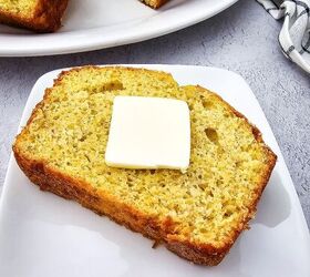 easy banana bread using yellow cake mix recipe, Thick slice of banana bread made with yellow cake mix topped with a pat of butter on a white plate
