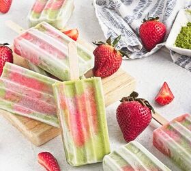 homemade matcha popsicles with strawberry layers, Matcha strawberry popsicles served on a wooden board with fresh strawberries and matcha powder