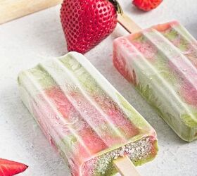 homemade matcha popsicles with strawberry layers, Close up of a frosty matcha strawberry popsicle with fresh strawberries in the background