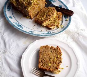 sweet eggplant pistachio quick bread, A loaf of bread on a blue transferware platter with a slice on a plate with a fork