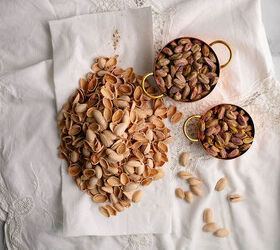 sweet eggplant pistachio quick bread, Shelled pistachios in copper cups on Battenburg cloth