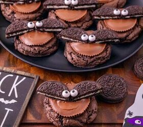 oreo bat cookies made with cake mix and reese s cups, Oreo bat cookies arranged on a black plate with Reese s peanut butter cups Oreos and Halloween decorations