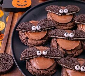 oreo bat cookies made with cake mix and reese s cups, Oreo bat cookies with Reese s peanut butter cups and candy eyes served on a black plate with Halloween decorations