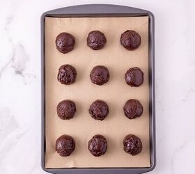 oreo bat cookies made with cake mix and reese s cups, Scoops of chocolate cookie dough arranged on a parchment lined baking sheet