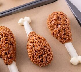 rice krispie turkey leg treats using pretzel bones, Rice Krispie turkey leg treats with white chocolate pretzel bones arranged on lined baking sheets