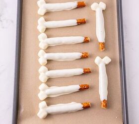 rice krispie turkey leg treats using pretzel bones, Finished white chocolate pretzel bones setting on a lined baking sheet