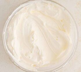 creamy pumpkin mousse easy no bake, A glass bowl filled with smooth fluffy whipped cream sits on a light textured surface
