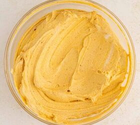 creamy pumpkin mousse easy no bake, A glass bowl filled with creamy light orange pumpkin mousse mixture swirled smoothly on a light colored surface